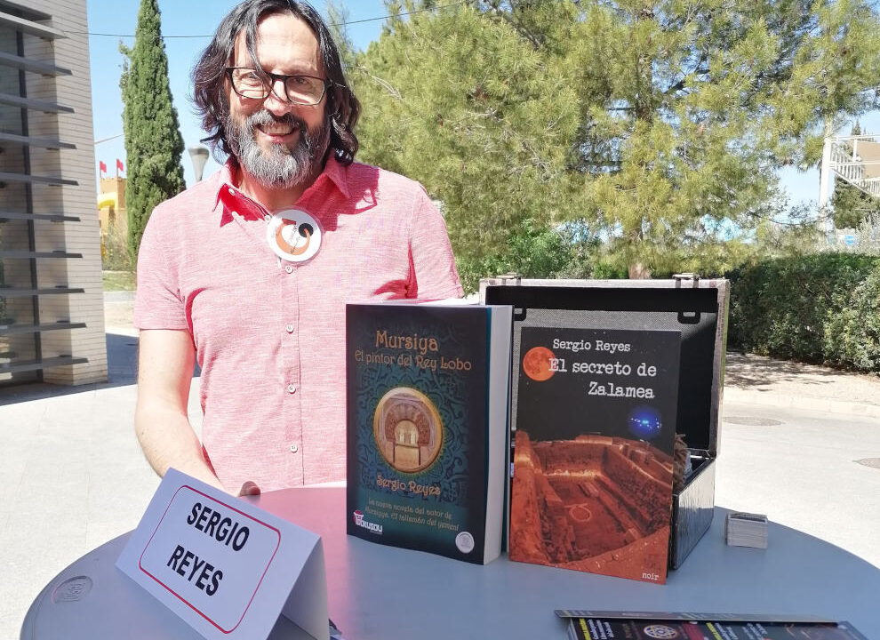Sergio Reyes en la feria del libro de Alcantarilla 2023 junto a su mesa de firmas